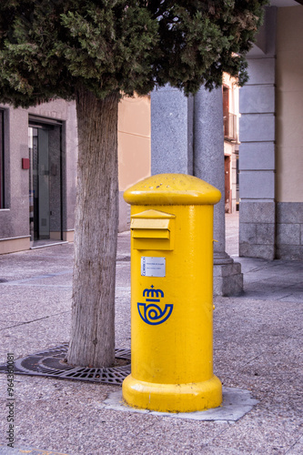 Yellow spanish post box on a village street