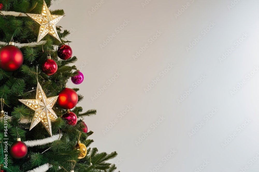 Fototapeta premium Brightly Adorned Christmas Tree with Shining Star Against Crisp White Background