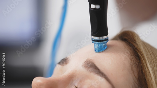 Wallpaper Mural A professional performs a hydropeeling facial treatment on a woman in a modern clinic, focusing on deep skin cleansing and rejuvenation. Perfect for showcasing advanced skincare techniques. Torontodigital.ca
