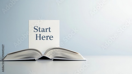An open book with a page marked 'Start Here,' symbolizing the beginning of a journey in learning or exploration.