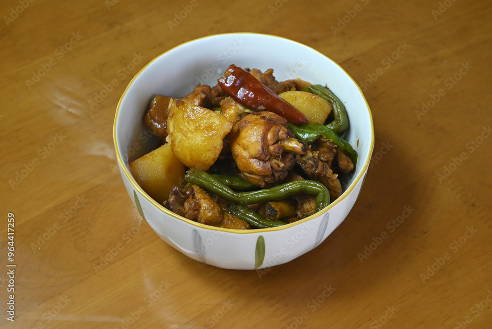 fresh braised chicken with potatoes and green beans and red peppers in the white bowl fresh braised chicken with potatoes and green beans and red peppers in the white bowl