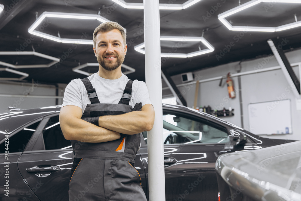 Confident Auto Mechanic Standing Proudly in a Modern Garage Environment Confident Auto Mechanic Standing Proudly in a Modern Garage Environment