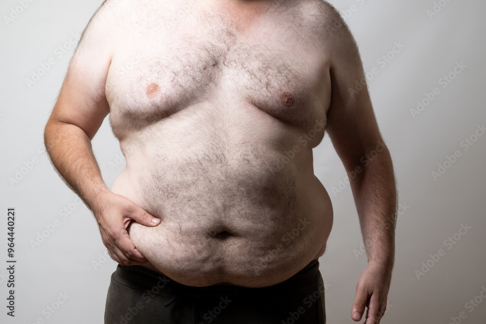 Naklejka premium Overweight Man's Torso Close-Up..
