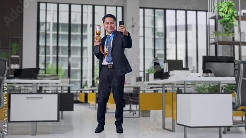 Wallpaper Mural Full Body Of Asian Business Man In A Suit And Tie With A Gold Medal Holding A Gold Trophy And Taking Photo On Smartphone As The First Winner In Office Torontodigital.ca