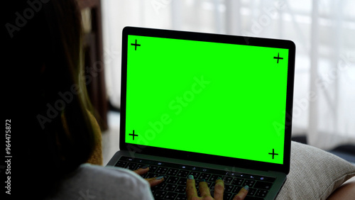 Woman scrolling computer screen. The screen is green for ready to use.	
