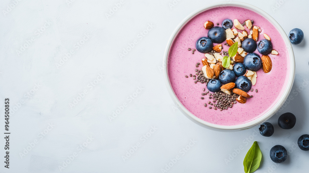 Colorful smoothie bowl topped with blueberries Colorful smoothie bowl topped with blueberries