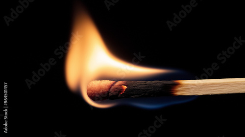 wooden matchstick burning on black background 