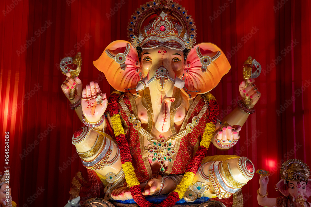 Fototapeta premium A Closeup shot Ganpati Installed in a Pandal during the 10 Day Ganesh Festival, the idols are immersed in heavy water bodies after the 10 days.
