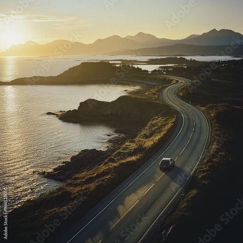 A car driving along the Atlantic Ocean Road at sunrise, with the first light of day casting long shadows on the road. photo