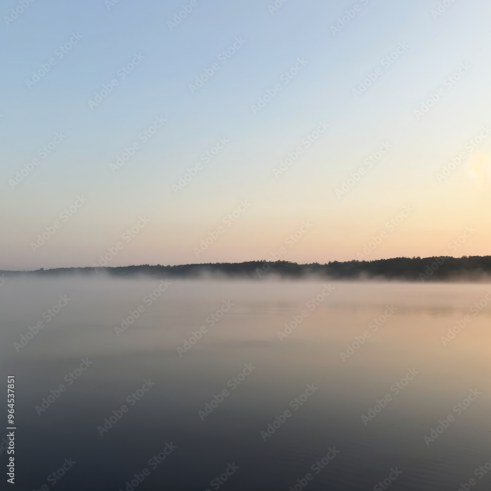 Fototapeta premium Serene Lake at Dawn with Morning Mist Rising Over Calm Water