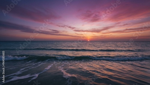 Stunning ocean sunset with a serene pink and purple horizon over calm waters.