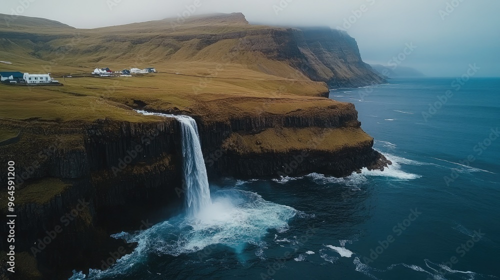The iconic Mulafossur Waterfall cascading into the ocean, with the village of Gsadalur in the background. The iconic Mulafossur Waterfall cascading into the ocean, with the village of Gsadalur in the background.