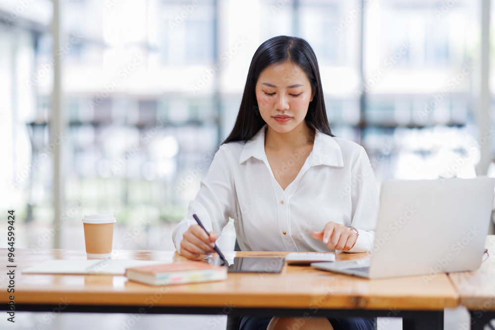 Asian Businesswoman Using laptop computer and working at office with calculator document on desk, doing planning analyzing the financial report, business plan investment, finance analysis concept.
Asian Businesswoman Using laptop computer and working at office with calculator document on desk, doing planning analyzing the financial report, business plan investment, finance analysis concept.