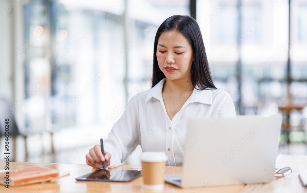 Asian Businesswoman Using laptop computer and working at office with calculator document on desk, doing planning analyzing the financial report, business plan investment, finance analysis concept.
Asian Businesswoman Using laptop computer and working at office with calculator document on desk, doing planning analyzing the financial report, business plan investment, finance analysis concept.