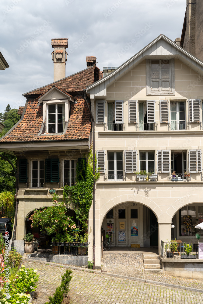 Typical building facade in downtown Bern Switzerland, with flowers in summer Typical building facade in downtown Bern Switzerland, with flowers in summer
