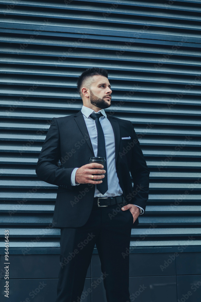 Relaxed businessman with drink to go in city Relaxed businessman with drink to go in city