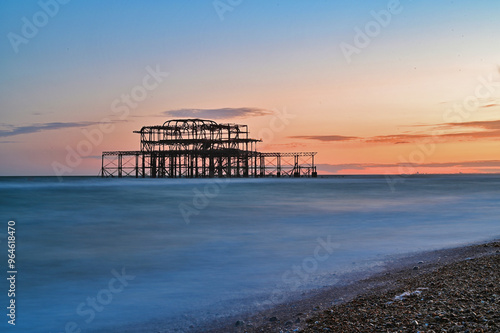 Remains of the West Pier on the beach of the English city of Brighton, while sunset  photo