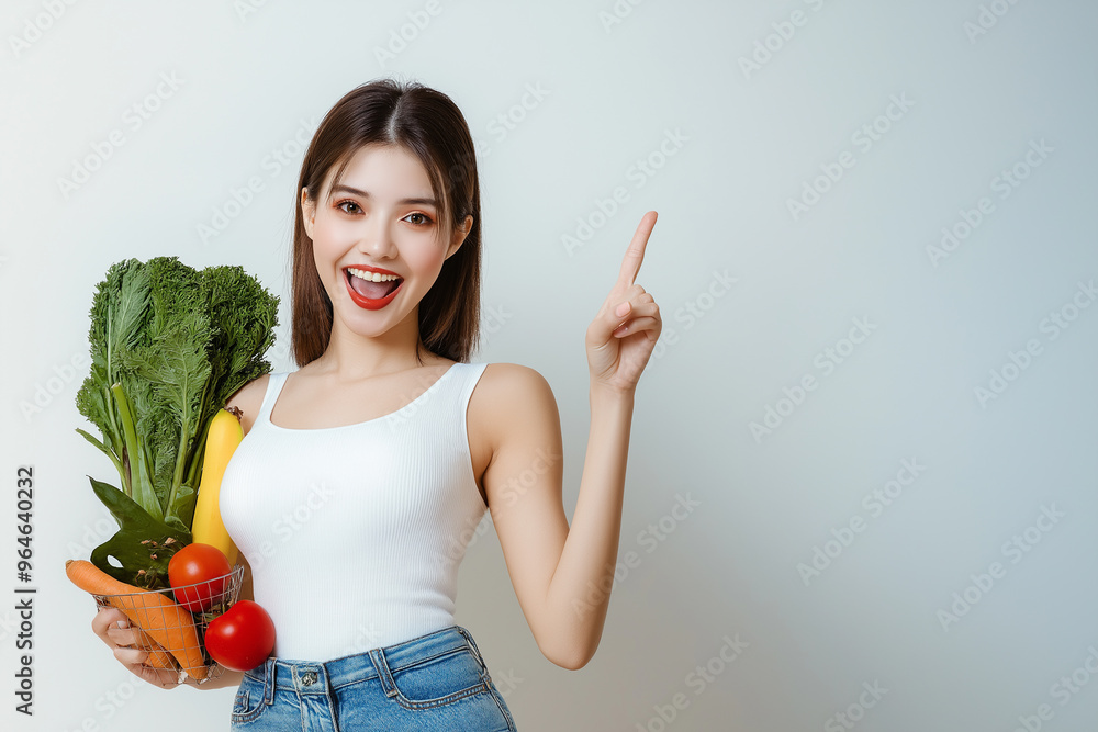 Smiling woman in sportswear holding green and orange juices in a modern kitchen surrounded by fresh vegetables and fruits. Healthy lifestyle Smiling woman in sportswear holding green and orange juices in a modern kitchen surrounded by fresh vegetables and fruits. Healthy lifestyle