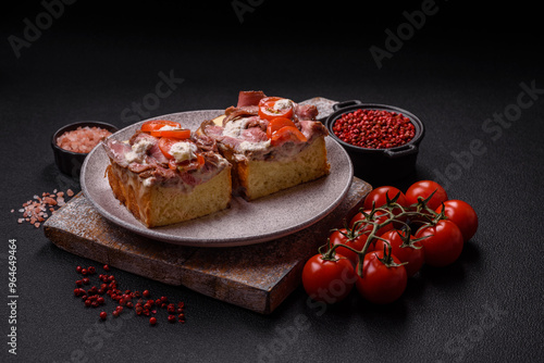 Sandwich with brioche bun, roast beef, tomatoes, stracciatello photo