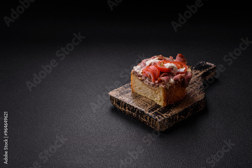 Sandwich with brioche bun, roast beef, tomatoes, stracciatello photo