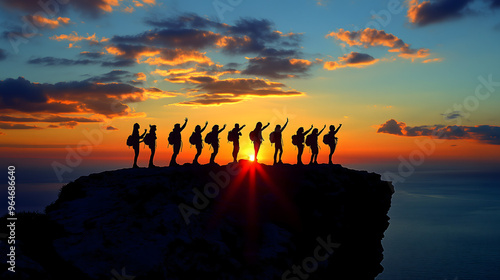 Siluetas de personas celebrando al amanecer en un acantilado como símbolo del trabajo en equipo  photo