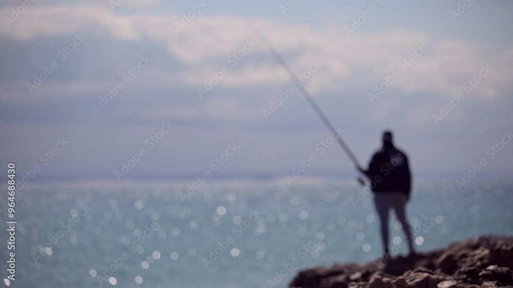 Blurred background of man seen fishing Blurred background of man seen fishing