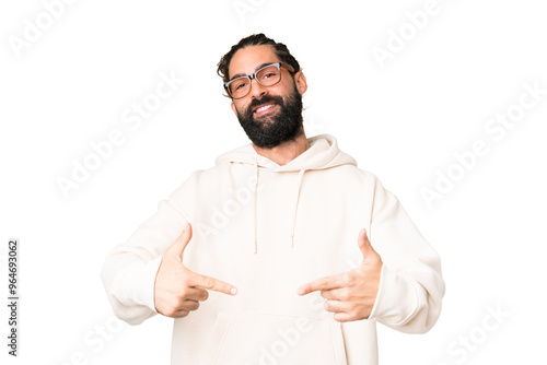 Young man with beard over isolated chroma key background proud and self-satisfied
