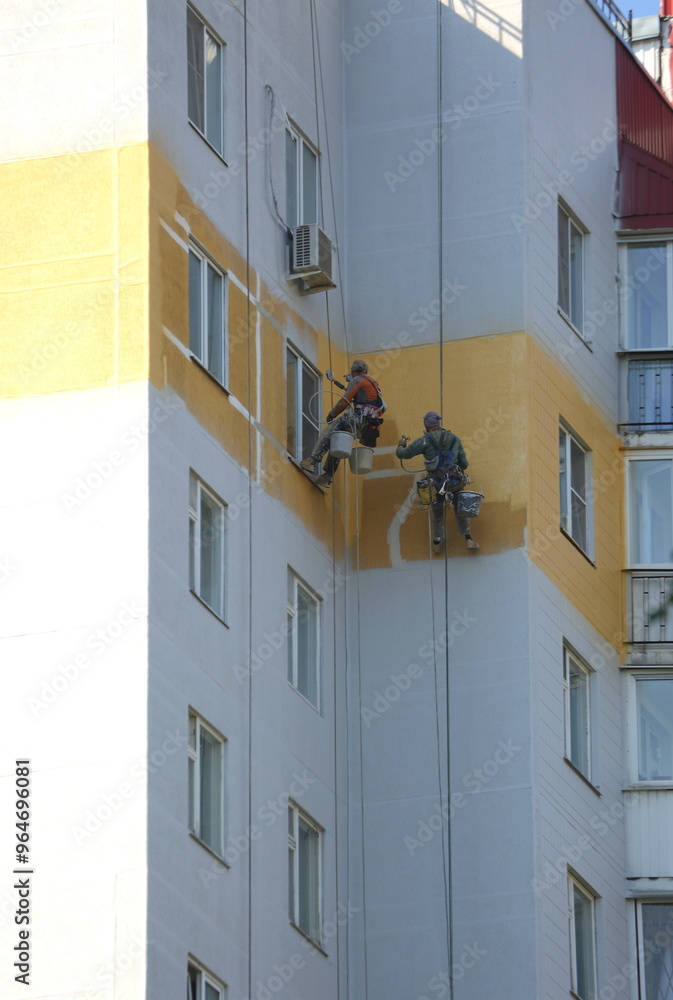 Two industrial climbers make cosmetic repairs to the facade of the building, Kollontai Street, St. Petersburg, Russia, September 08, 2024 Two industrial climbers make cosmetic repairs to the facade of the building, Kollontai Street, St. Petersburg, Russia, September 08, 2024