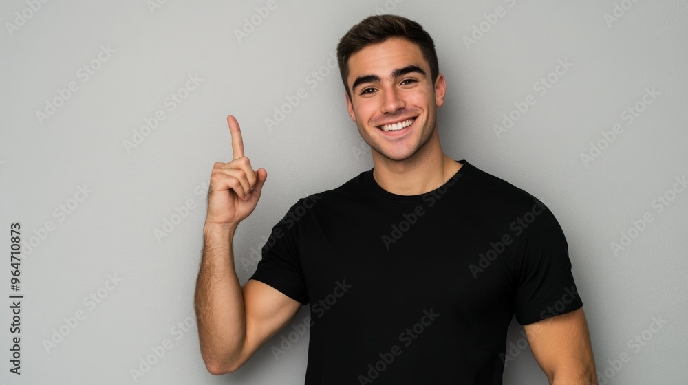 Young Man Pointing Upward with a Smile Young Man Pointing Upward with a Smile