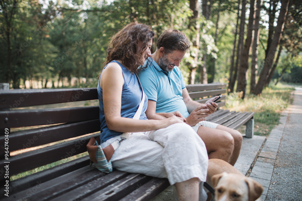 Couple enjoy time together in the park with dogs Couple enjoy time together in the park with dogs