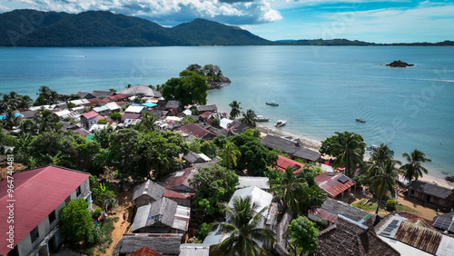 Aerial view of Nosy Komba Island in Madagascar showcasing its vibrant village and lush tropical surroundings under clear skies photo