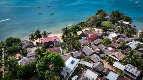 Aerial view of Nosy Komba Island showcasing houses, palm trees, and turquoise waters of Madagascar photo