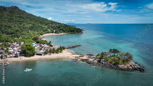 Aerial view of Nosy Komba Island showcasing lush coastlines and tranquil waters in Madagascar during a sunny day photo