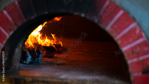 Traditional wooden pizza oven with flames