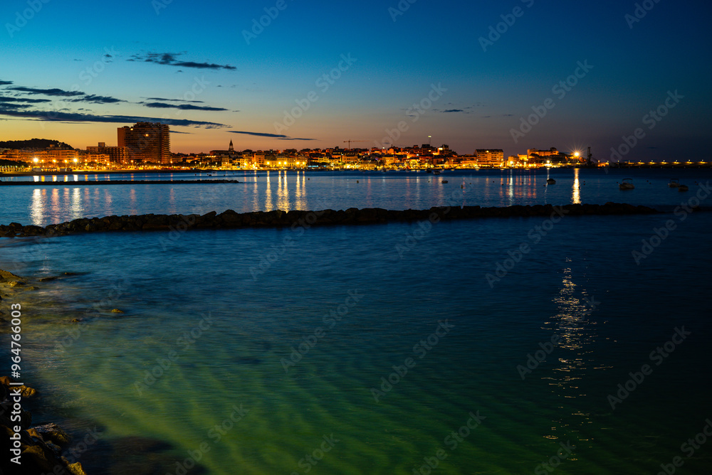 View of a beach with a sunrise in the background View of a beach with a sunrise in the background