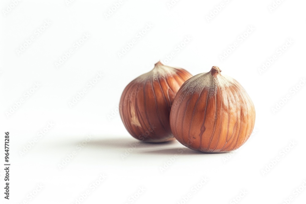 Obraz premium Onions sit side by side on a white surface, perfect for use in food or still life photography
