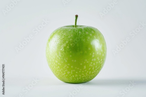 A single green apple sitting on a clean and minimalist white background photo