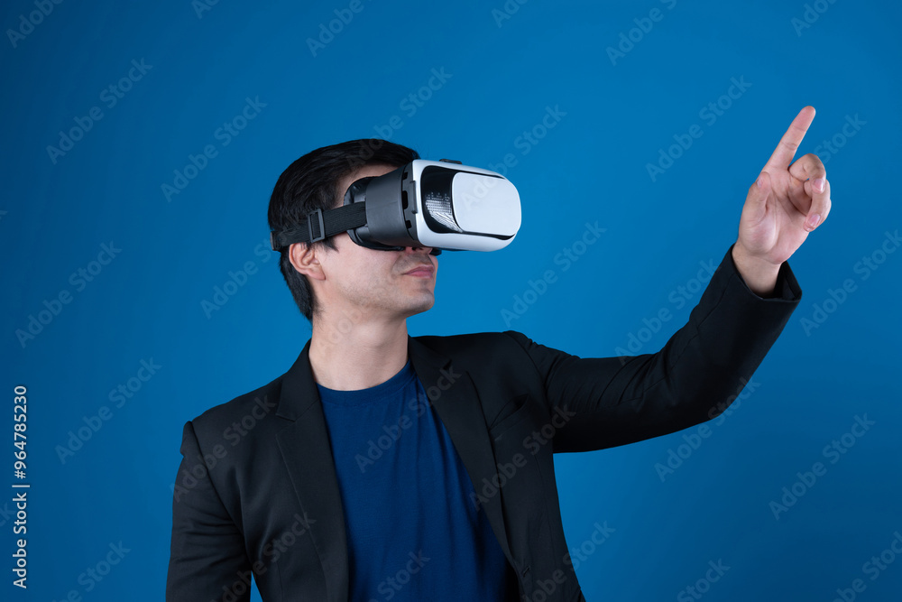 Profile businessman wearing VR headset looking to connect metaverse pointing to choose interesting data isolated blue background futuristic analytics communication tech virtual reality. Contrivance. Profile businessman wearing VR headset looking to connect metaverse pointing to choose interesting data isolated blue background futuristic analytics communication tech virtual reality. Contrivance.