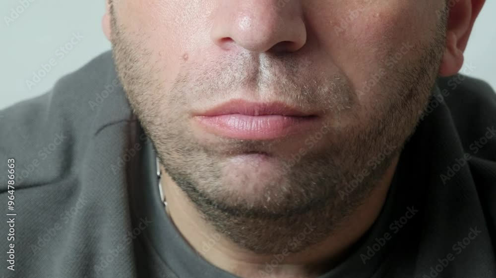 A close-up video showing a man taking a bite of a pizza slice, highlighting the texture of the pizza and the man's mouth as he eats A close-up video showing a man taking a bite of a pizza slice, highlighting the texture of the pizza and the man's mouth as he eats