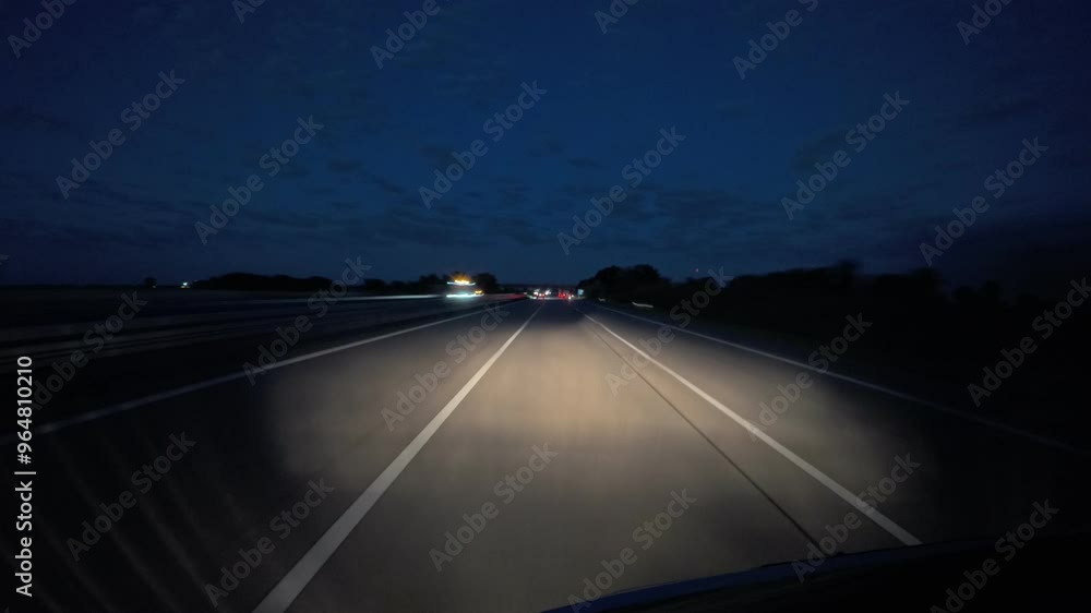 Timelaps of a car driving on a german highway during blue hour at night, headlights lights up die road,summer day Timelaps of a car driving on a german highway during blue hour at night, headlights lights up die road,summer day