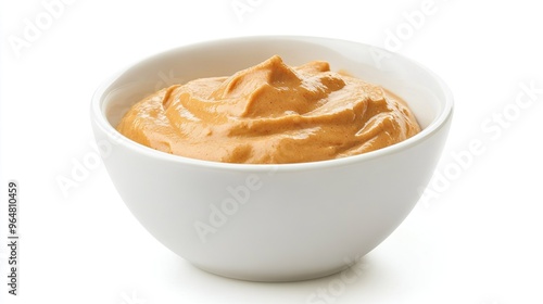 A white bowl filled with a creamy, orange sauce