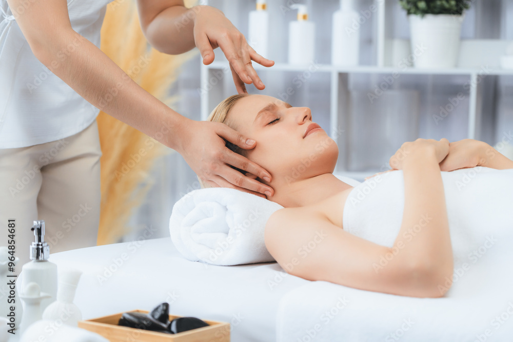 Obraz premium Caucasian woman enjoying relaxing anti-stress head massage and pampering facial beauty skin recreation leisure in dayspa modern light ambient at luxury resort or hotel spa salon. Quiescent