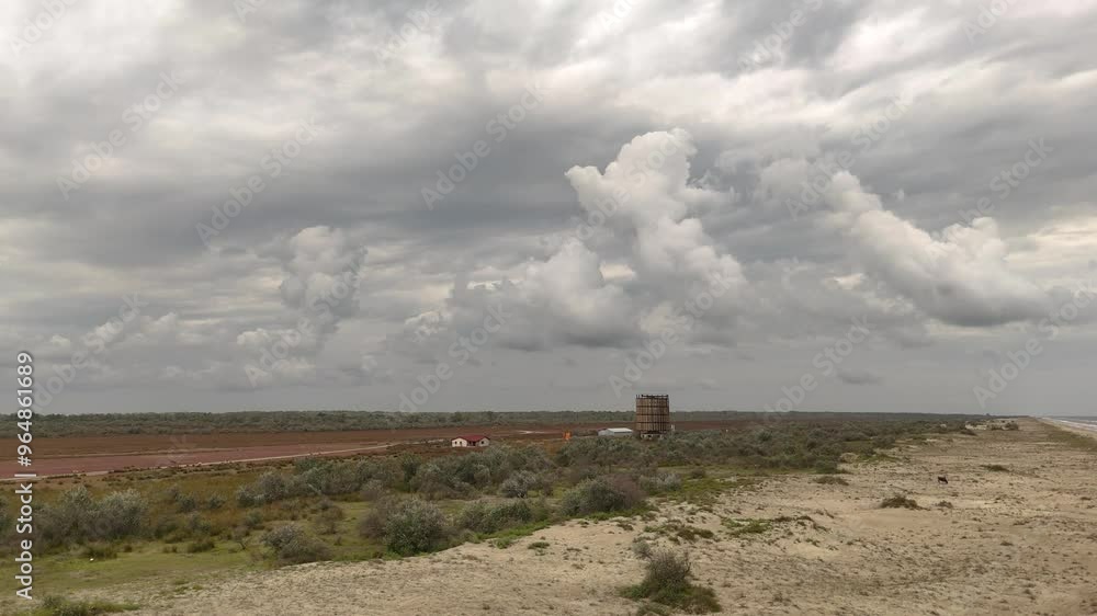 Aerial landscape of a cattle ranch with a grain silo near the black sea coast line with storm clouds in the background Aerial landscape of a cattle ranch with a grain silo near the black sea coast line with storm clouds in the background