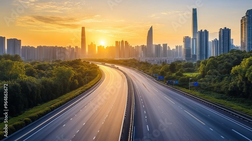 The sun rises over Guangzhou, painting the modern city skyline in golden light. Below, a wide asphalt highway stretches out, leading into the heart of the bustling metropolis.