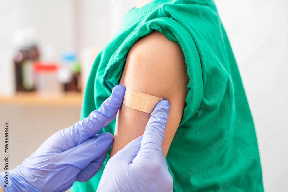 Fototapeta premium Shot of a little boy getting a vaccination by a doctor in a hospital