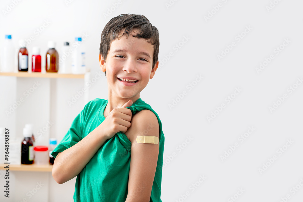 Portrait, happy and child with plaster at hospital.Face, smile and boy child with bandage after vaccine, injury or wound for healthcare, first aid and excited with copy space
