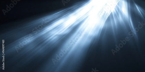 Abstract blue light beams shining on a dark background.