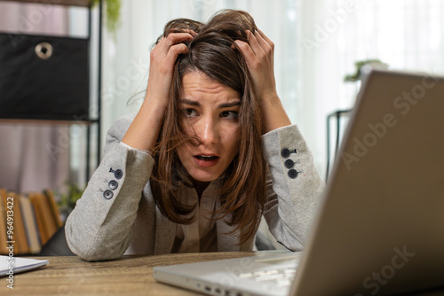 Tired sleepy young businesswoman sitting at home office table with laptop overworked lazy bored lady worker feel fatigue exhausted of work deprived. Exhausted workaholic freelancer workaholic girl photo