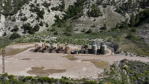 Aerial oil well rigs pumping storage Utah 2. Oil wells, pumps ands storage tanks in a high mountain valley in north east Utah. Machinery and technology environmental pollution. photo