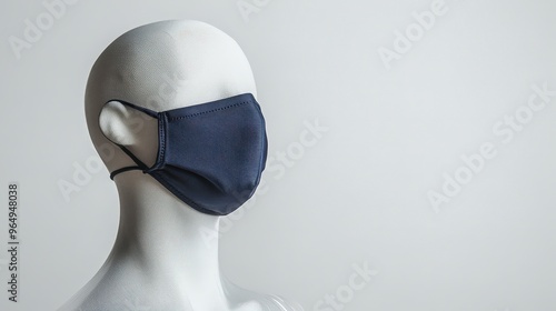 Stylish Navy Blue Fabric Face Mask on Transparent Mannequin in Studio Setting Captured with Lyca Camera at 45-Degree Angle photo